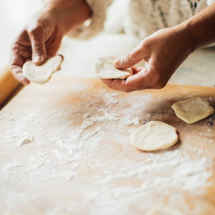 person holding dough on her hands
