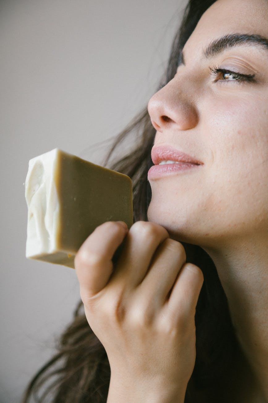 a woman holding a soap bar